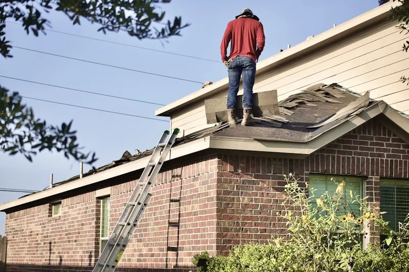 Professional roofer working on a residential roof in Pine Lane
